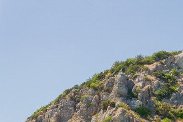 Mountains and rocks on the beach in summer on a Sunny day