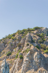 Mountains and rocks on the beach in summer on a Sunny day
