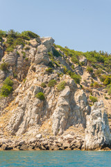 Mountains and rocks on the beach in summer on a Sunny day