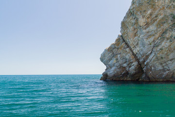 Mountains and rocks on the beach in summer on a Sunny day