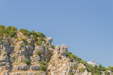 Mountains and rocks on the beach in summer on a Sunny day