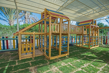 Fototapeta na wymiar Large wooden climbing frame in children's playground area