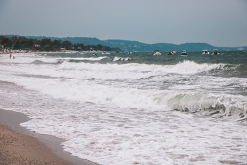 Selective focus on the seascape overlooking a sea storm off the coast on the blurred background.