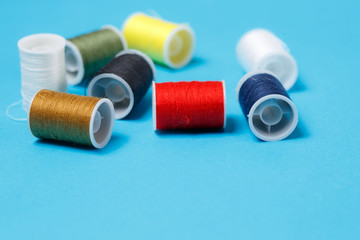 Spools of Colorful Thread on Neutral Background