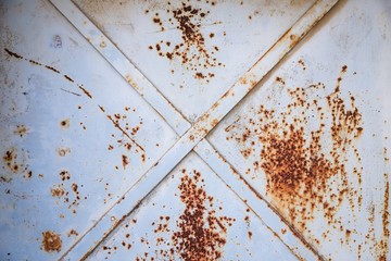 Old gray vintage door. Rusty metal surface, rust texture background
