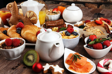 Breakfast served with coffee, orange juice, croissants, cereals and fruits. Balanced diet. Continental breakfast on christmas