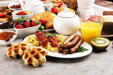 Breakfast served with coffee, orange juice, croissants, cereals and fruits. Balanced diet. Continental breakfast with granola and fruits