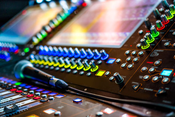 Sound effects soundboard and microphone. Sound recording studio background. Sound mixing desk with...