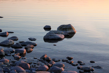 Stones in calm water at dusk