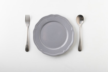 Empty plate spoon and fork