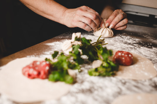 Chef of a Georgian restaurant sculpts khinkali. Khinkali cooking process