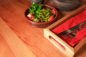 Georgian green bean dish on a table of a restaurant. Dish of Georgian cuisine