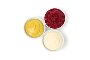 Tasty sauces in bowls isolated on white background