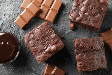 Chocolate cake slices and chocolate on black background, close up