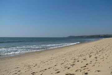 Fototapeta na wymiar Keri beach, North Goa, India. Sandy coast and blue sky