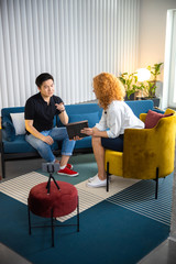 Woman using gadgets during interview stock photo