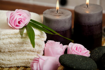 Soap pink roses.  candles and face towels in  a spa 
