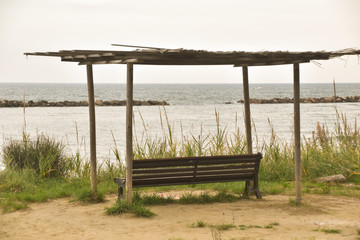 bench with a roof facing the beach