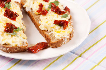Delicious fresh scrambled eggs and dried tomatoes sandwich