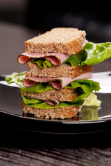 Big layered sandwich with lettuce and beef