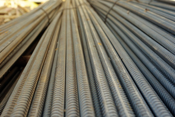 selected focus view stack of deformed reinforcement steel or iron bars. Background horizontal random pattern of deformed iron bars.