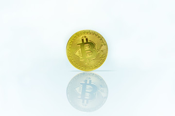 Crypto currency coin with reflection on white surface. 