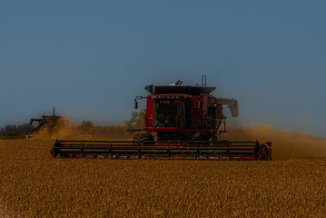 combine harvester working on barley field
