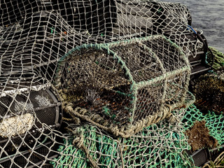 Old used fish and crab trap, Close up. Rusty metal frame covered with net.