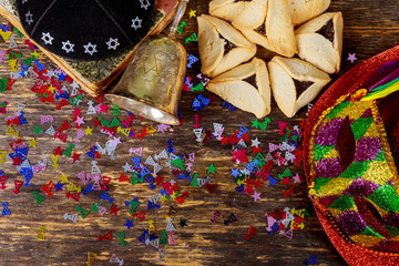 Traditional jewish carnival holiday Purim celebration and hamantaschen cookies and mask, kippa