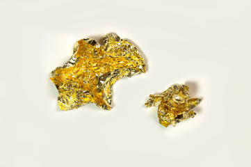 Folded paper sheets of gold isolated on white