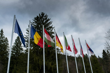 Waving european flags in local World War 1 and 2 memorial park in Transylvania, Romania.