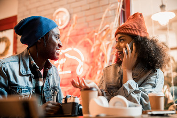 Pretty young woman talking on smartphone outdoors