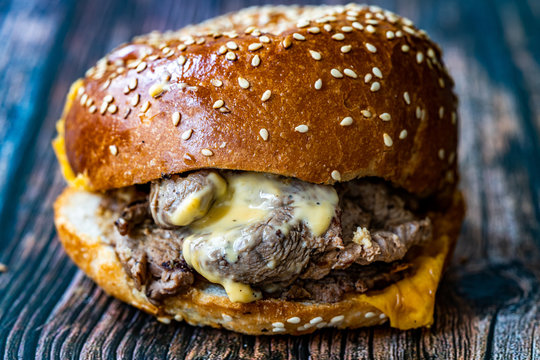 Steak Burger made with Lamb Meat Lokum and Cheddar Cheese / Hamburger or Cheeseburger on Wooden Surface.