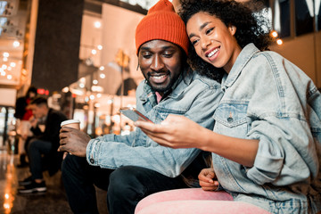 Happy pretty lady is using smartphone outdoors