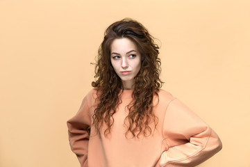 Portrait of a young beautiful woman wearing sweatshirt posing isolated over yellow background