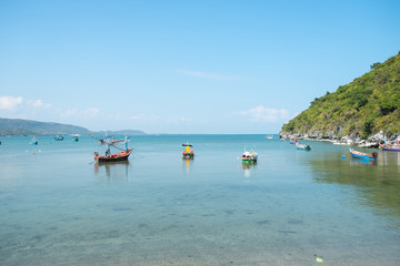 Fototapeta na wymiar fisherman boats on the ocean with cliff and sky background in Thailand