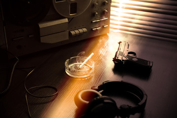 Reel tape recorder for wiretapping. KGB spying conversations. Black gun nearby. Ashtray with a...
