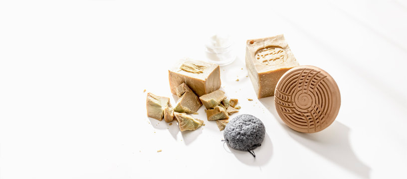 Aleppo soap with pumice and sponge on a white background seen from above