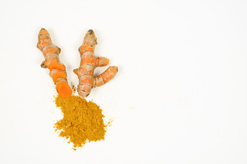 Fresh turmeric and turmeric powder on a white background