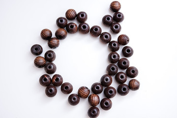 brown beads on a white table with circle copy space