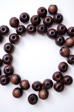 brown beads on a white table with circle copy space