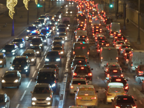 Long Exposure Of Big Urban Night Traffic. The Lights Of Blurred Motion At The Highway. The Road Is Filled Out Cars. Top View / View From Above.