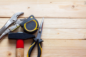 Hand tools on a wooden background