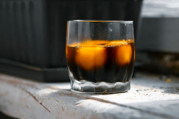 Misted transparent glass with bright egg yolks in a Japanese marinade, close-up with a blurred background.
