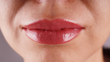 Female lips after permanent tattooing close-up.