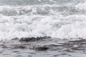 Waves on the beach. A surge of water ashore.