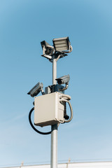 Security cameras on a pole near the road. CCTV camera