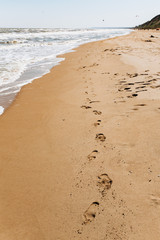 Footprints on beach background. A footprint of human feet on the sand near the sea