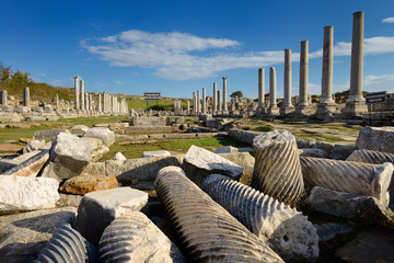 Collection of pillars in ruins of water canal on main street colonade of Perge Turkey