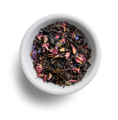 Black tea with natural aromatic additives. Top view on white background